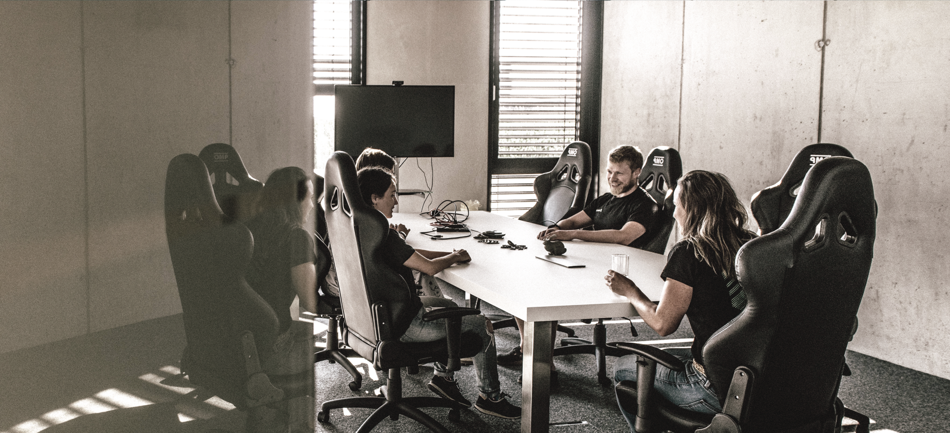 Colleagues sit together at the meeting table